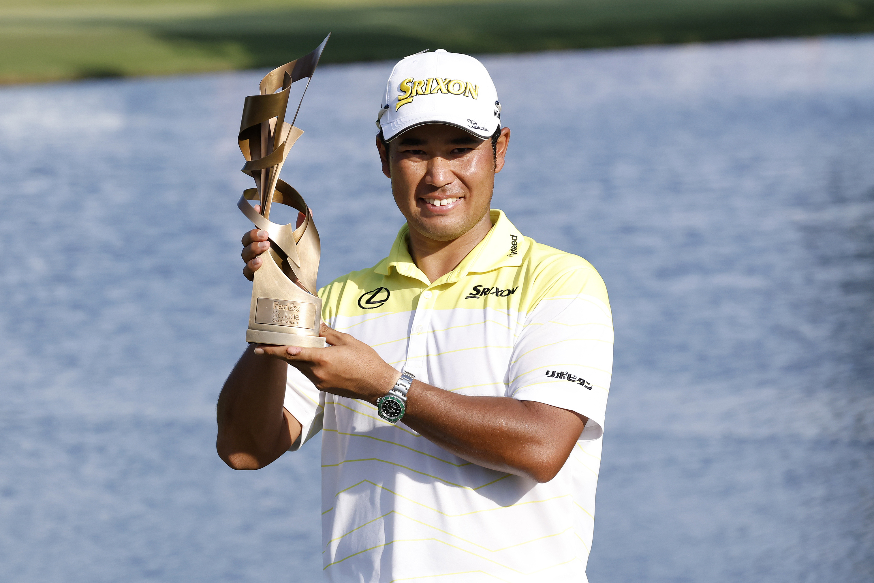 Hideki Matsuyama holds a trophy