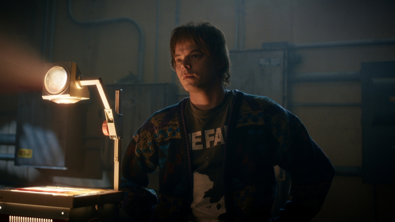 Jonathan looking at a projected image in Stranger Things 5