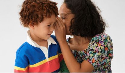 A little girl and boy whispering