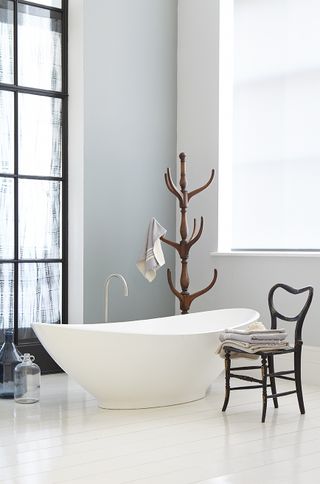 a neutral white bathroom with a free-standing tub decorated in Little Green Shallows, best cool toned white paint