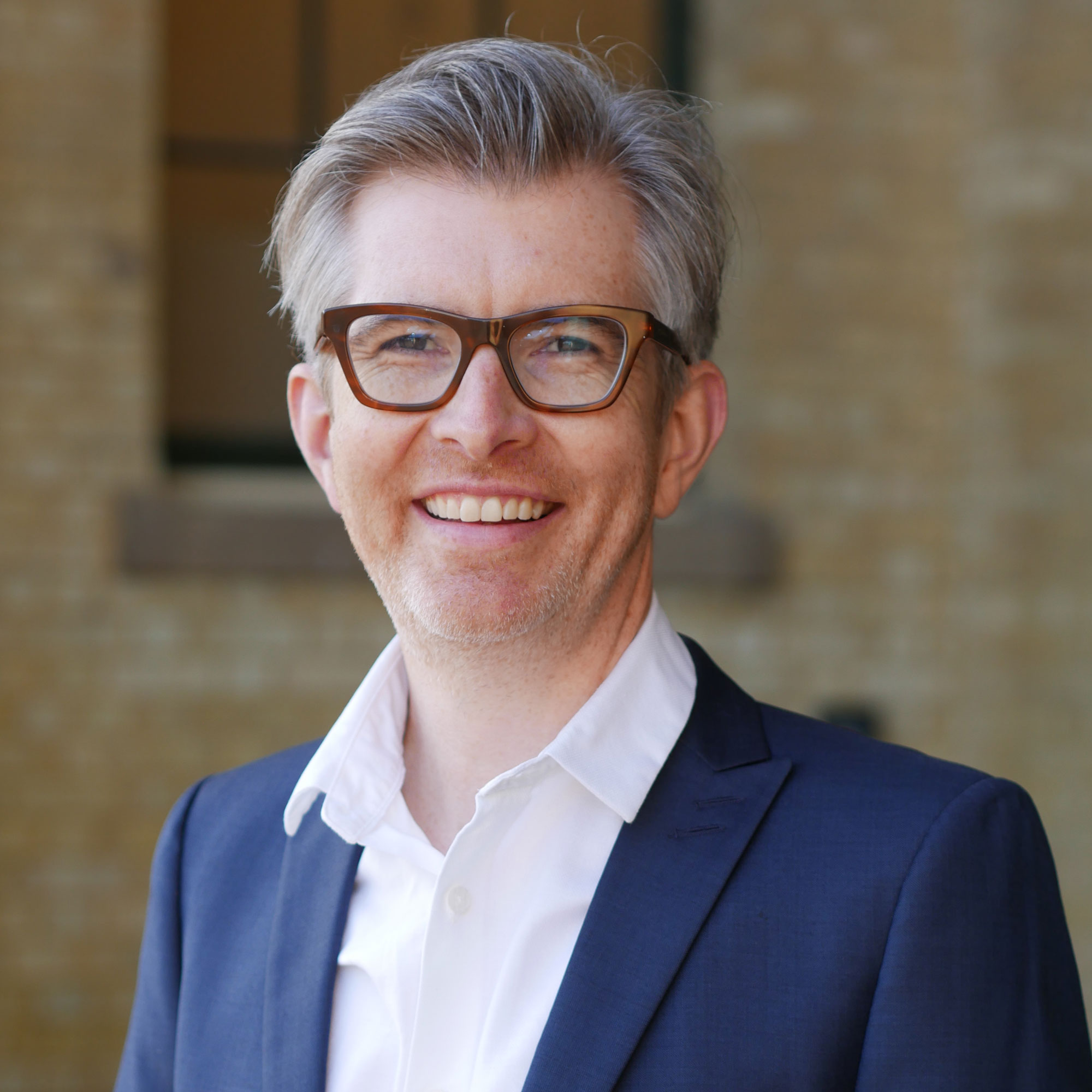 Gareth Malone stood in a cloister