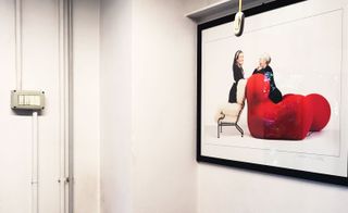 Framed photo of 2 women on chairs