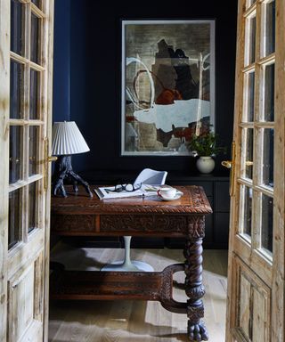 office with black walls and antique desk