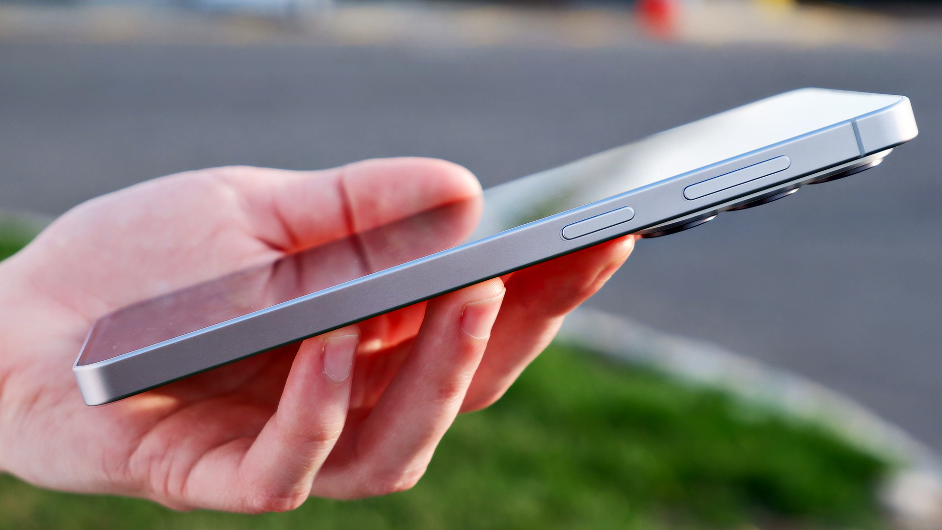 The side buttons of the Samsung Galaxy S26 Plus against an outdoor background.