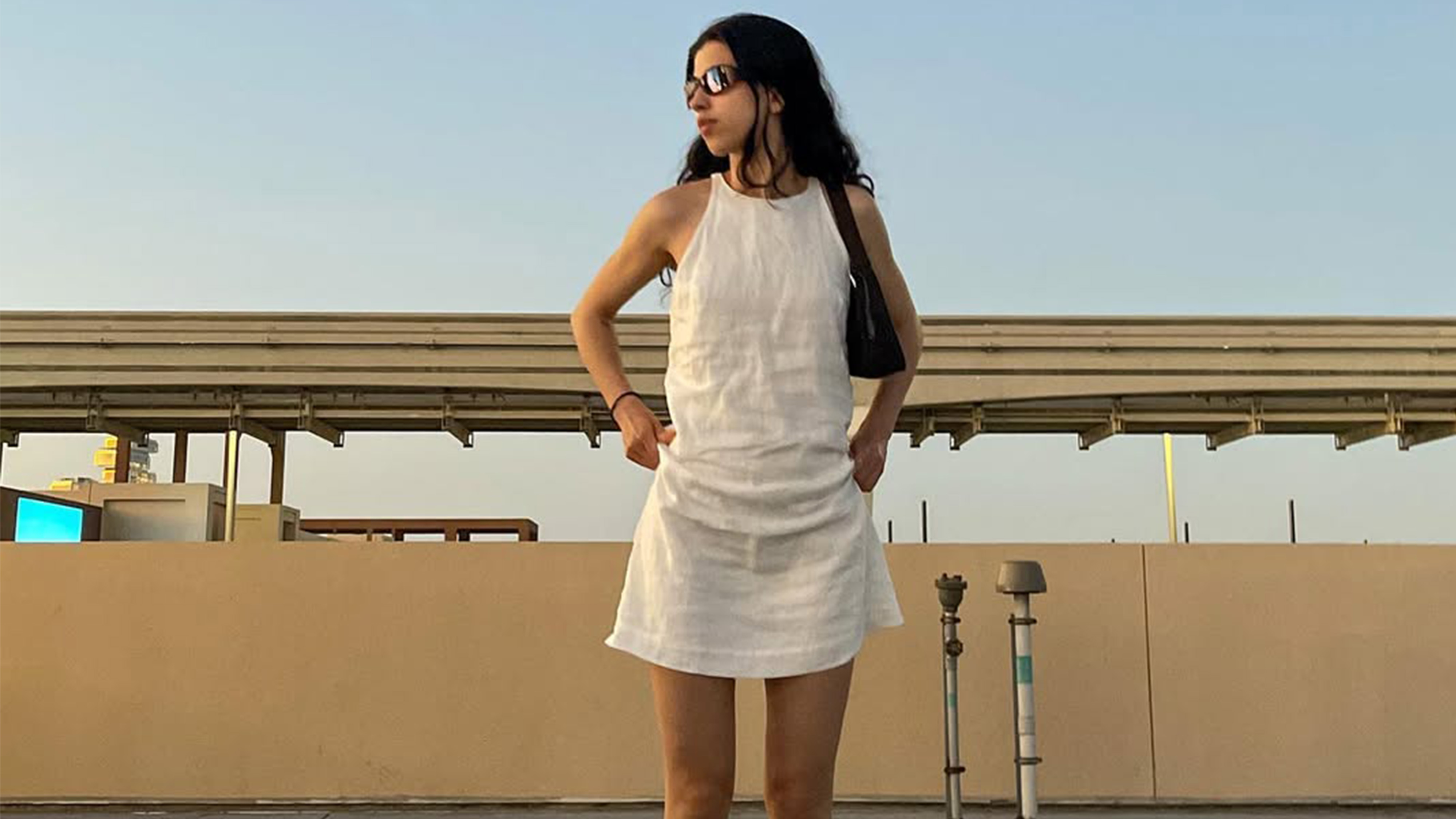 Daniela Contreiras wearing all white with sunglasses.