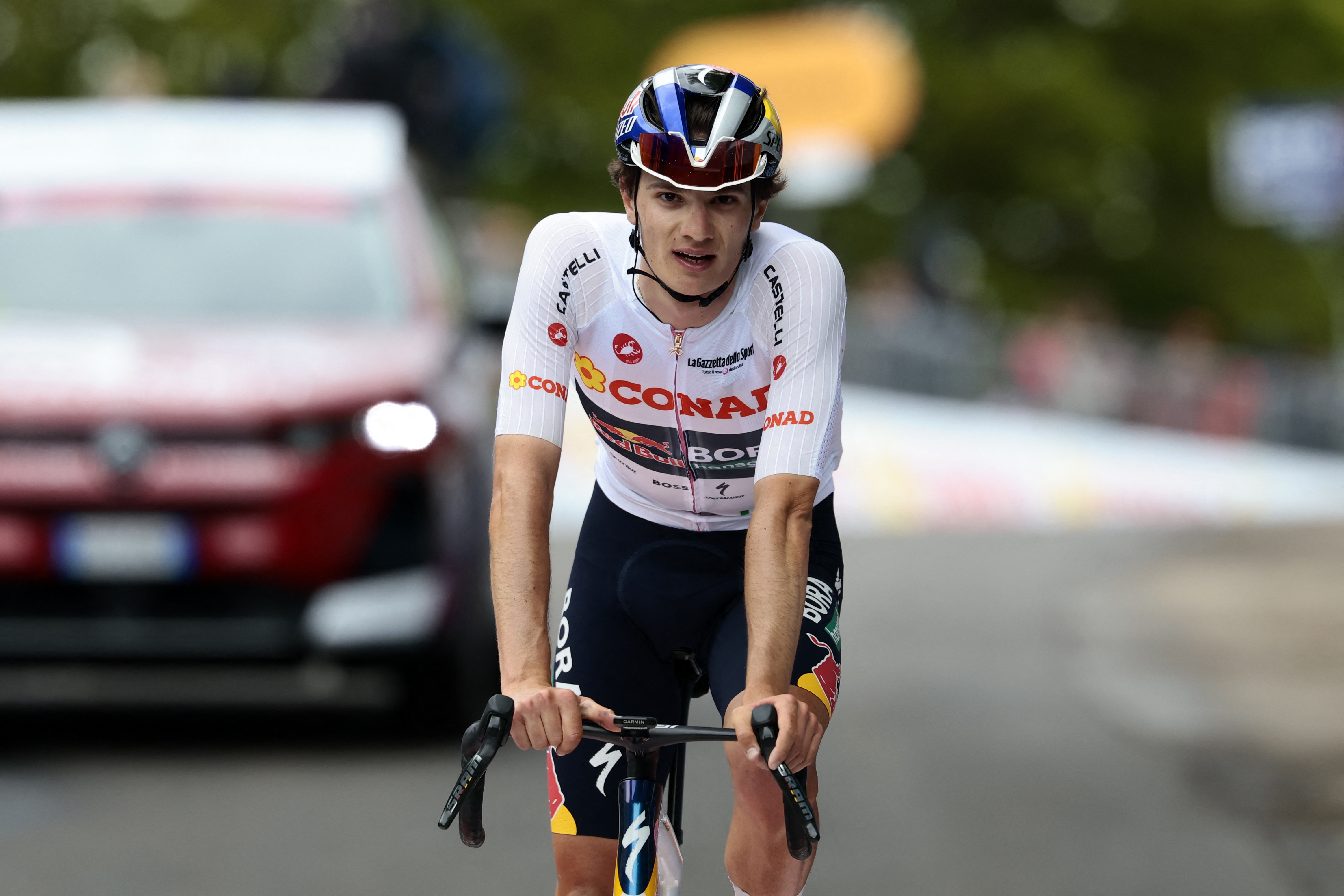 Red Bull - BORA - hansgrohe Italian rider Giulio Pellizzari crosses the finish line at the end of the 9th stage of the Giro d'Italia 2026 - Tour of Italy cycling race between Cervia and Corno alle Scale, near Doganaccia, central Italy on May 17, 2026. (Photo by Luca Bettini / AFP)