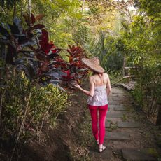 woman walking through tropical forest