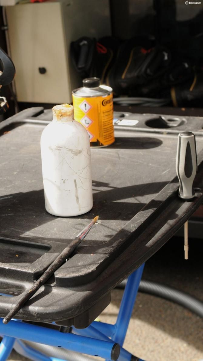 A plastic bottle for applying a thin bead of glue, and a paint brush to spread it evenly