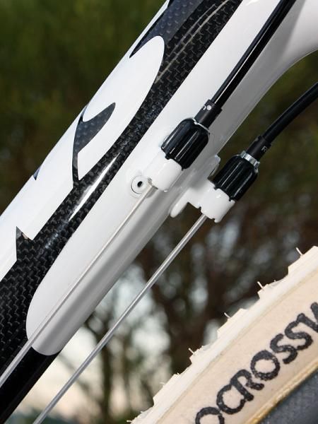 Barrel adjusters are neatly integrated on to the down tube.