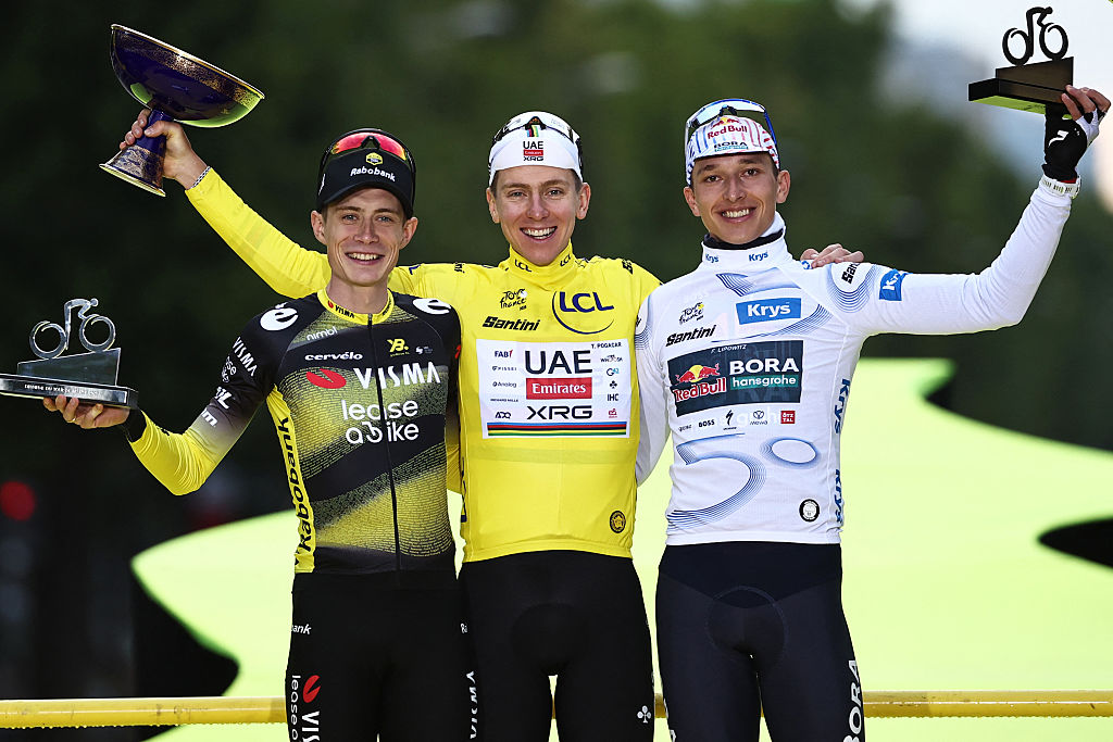 Overall winner UAE Team Emirates - XRG team&#039;s Slovenian rider Tadej Pogacar (C) wearing the overall leader&#039;s yellow jersey, second-placed Team Visma - Lease a bike team&#039;s Danish rider Jonas Vingegaard (L), and third-placed Red Bull - BORA - hansgrohe team&#039;s German rider Florian Lipowitz (R) celebrate on the podium after the 21st and final stage of the 112th edition of the Tour de France cycling race, 132.3 km between Mantes-la-Ville and Paris Champs-&amp;Eacute;lysees, on July 27, 2025. (Photo by Anne-Christine POUJOULAT / AFP)