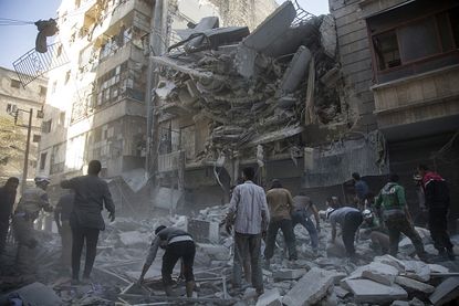 The aftermath of a bombing in Aleppo, Syria, on Tuesday.