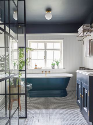 a bathroom with paneling and a painted ceiling