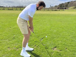 Monty performing a chip shot in the NOBULL lightweight textured Polo