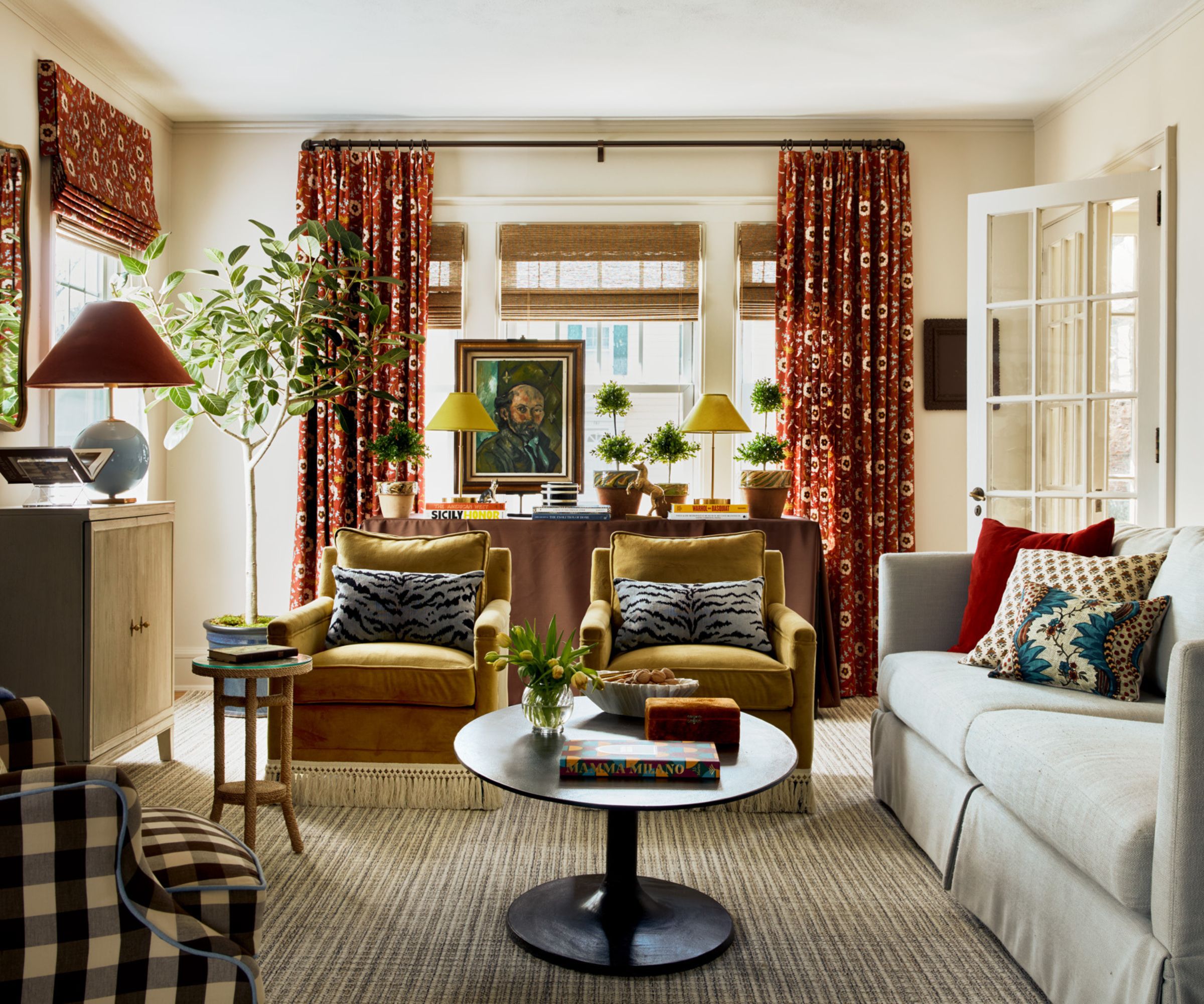 cozy living room decorated with fall colors with ochre velvet armchairs and burgundy burnt orange fabric accents