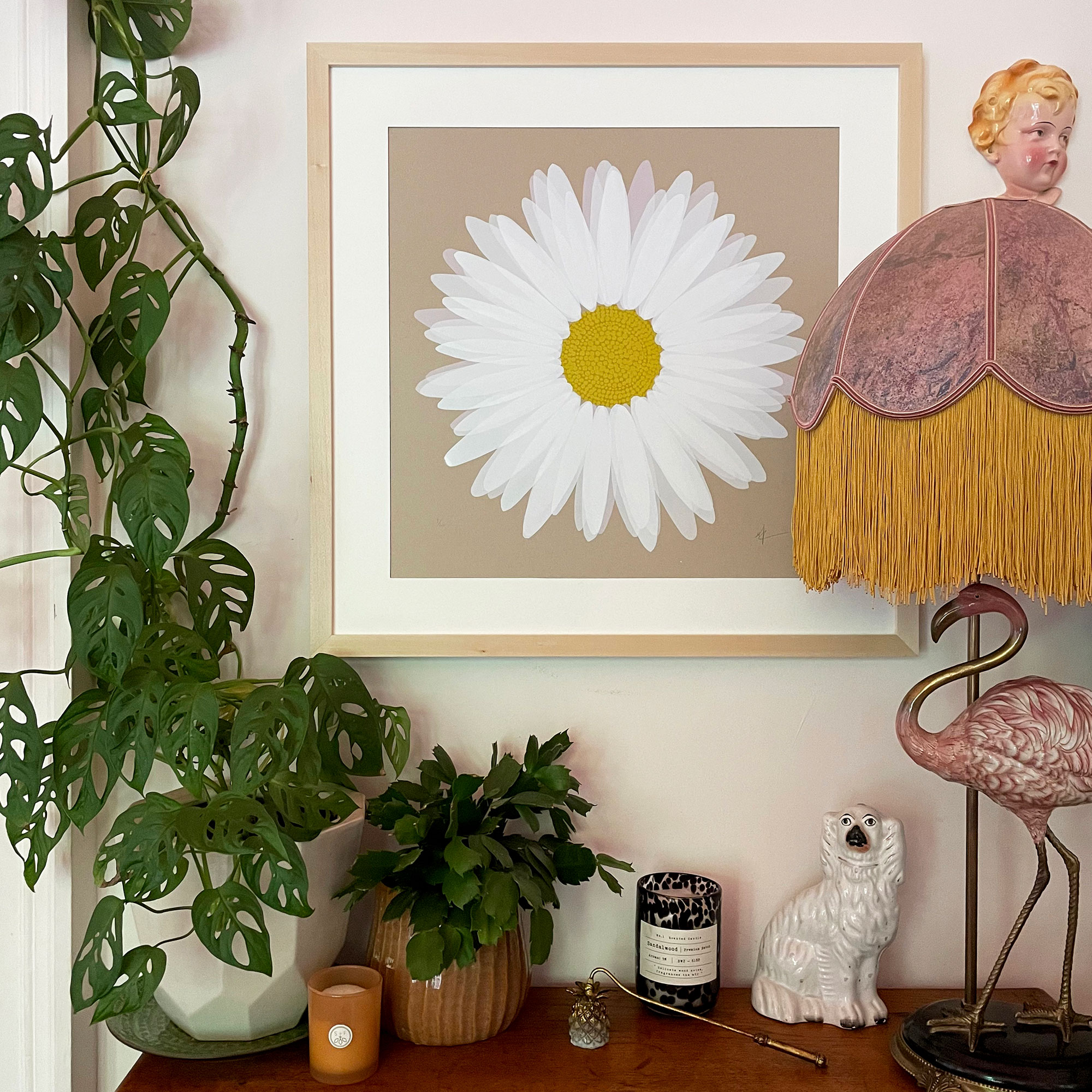 Daisy paintin on neutral wall above sideboard