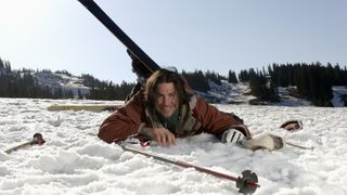 A skier smiling after falling