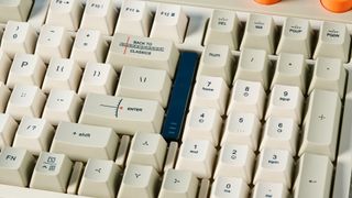 The Lofree Block keyboard on a stone surface with a blue wall in the background.