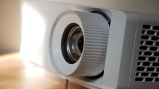 Optoma UHZ66 projector on table