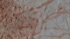 A region of Europa's surface dubbed Chaos Transition shows messy blocks on the left and long ridges on the right.