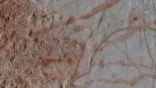 A region of Europa's surface dubbed Chaos Transition shows messy blocks on the left and long ridges on the right.