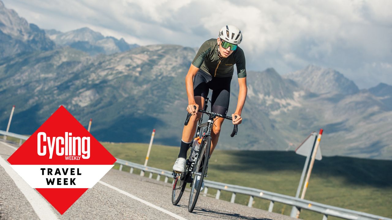 Image shows a rider cycling in the mountains