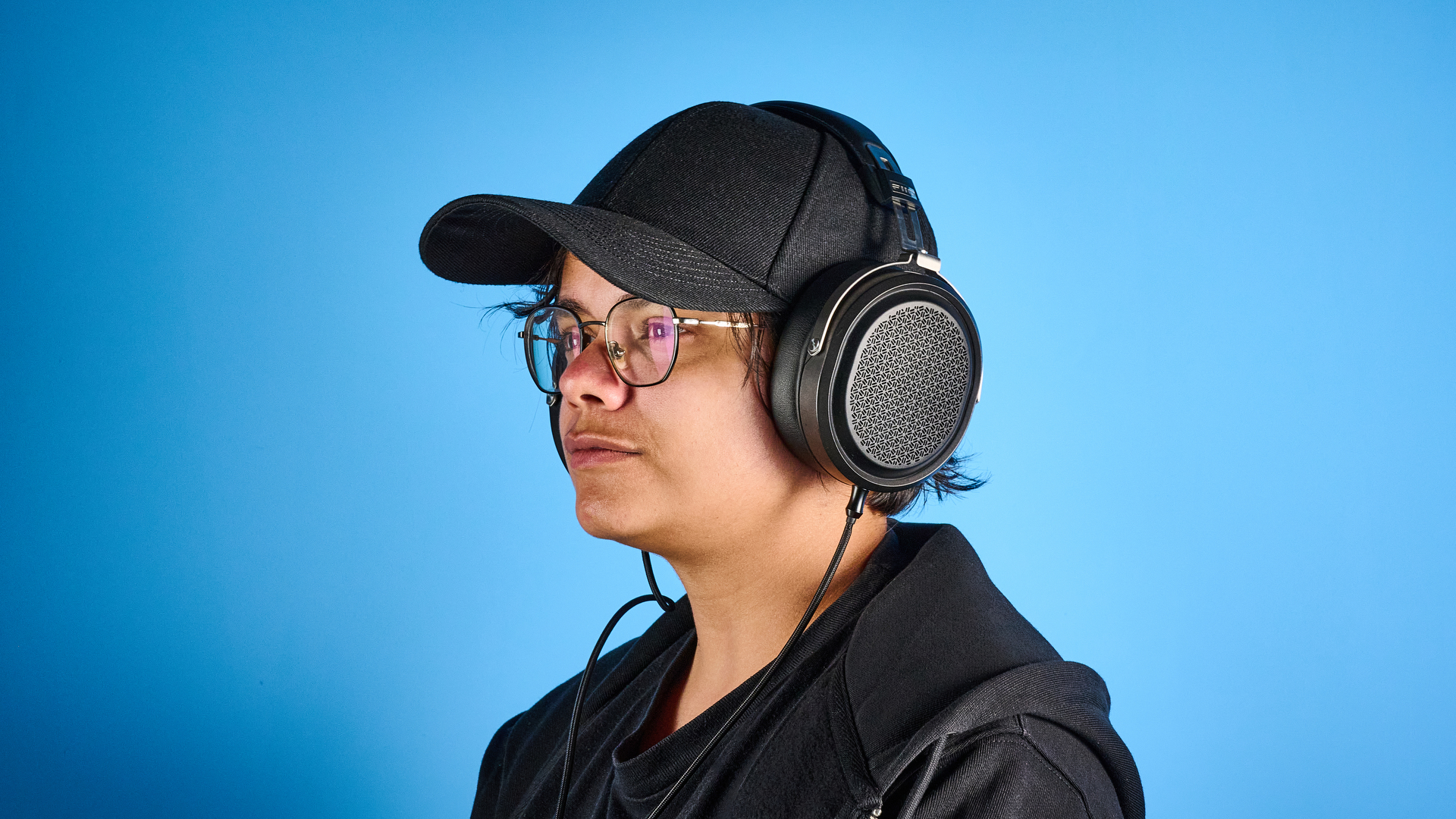 the fiio ft1 pro wired open-back headphones photographed with a blue tom's guide background