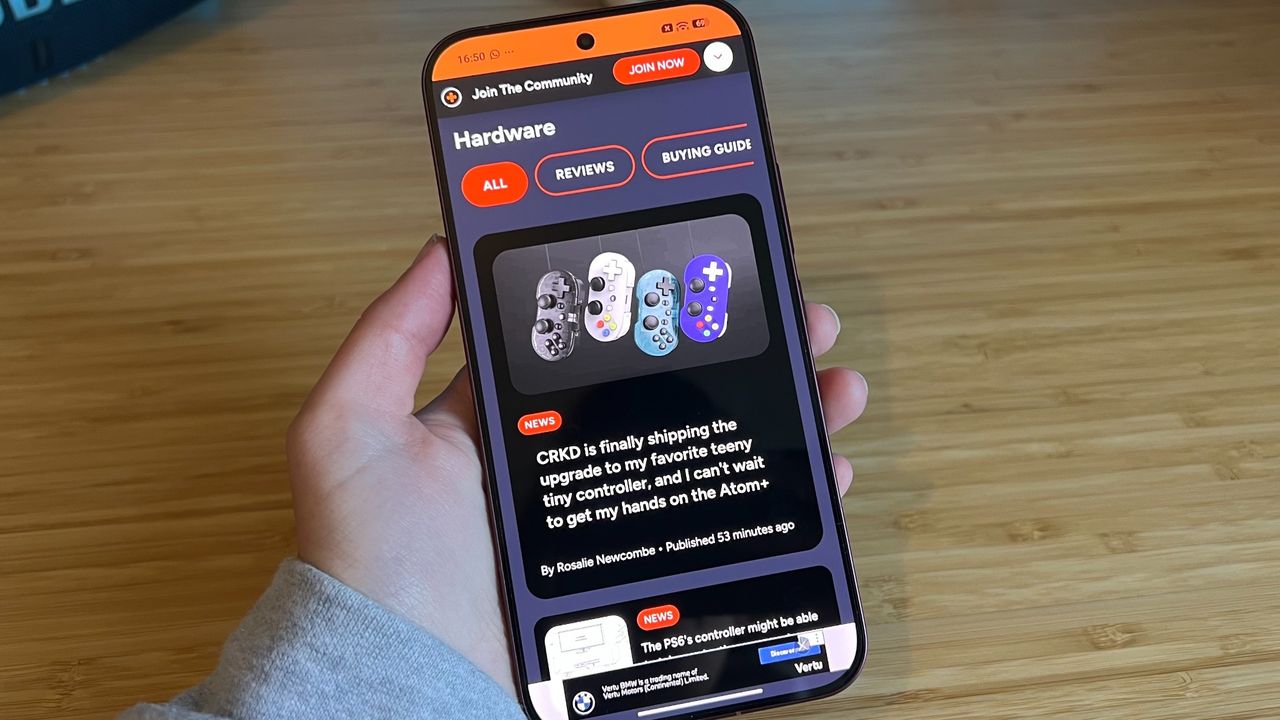 Poco F9 Ultra showing GamesRadar+ homepage on its display while being held in the hand
