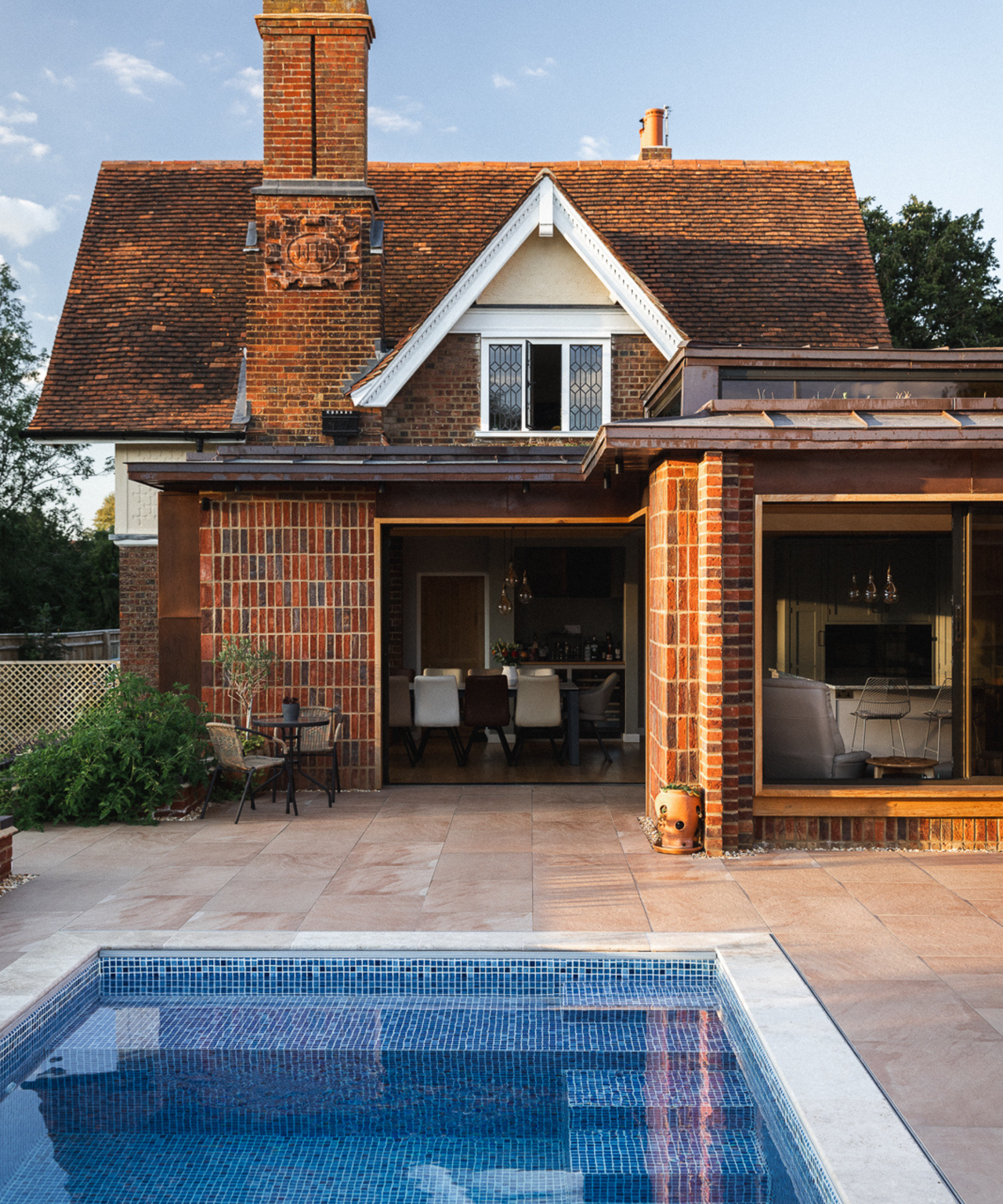 exterior of house with L-shaped extension and pool