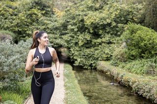 Woman running down the river, trying to lose lockdown weight