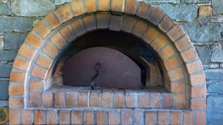 picture of a brick pizza oven with soot stains on it