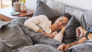 Woman sleeping whilst wearing the Fitbit Inspire HR