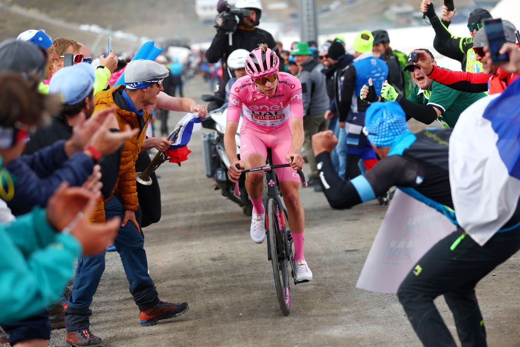 LIVIGNO MOTTOLINO ITALY MAY 19 Tadej Pogacar of Slovenia and UAE Team Emirates Pink Leader Jersey competes in the breakaway climbing the Mottolino 2387m while fans cheer during the 107th Giro dItalia 2024 Stage 15 a 222km stage from Manerba del Garda to Livigno Mottolino 2387m UCIWT on May 19 2024 in Livigno Mottolino Italy Photo by Luca Bettini PoolGetty Images