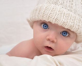Adorably baby with bright blue eyes.