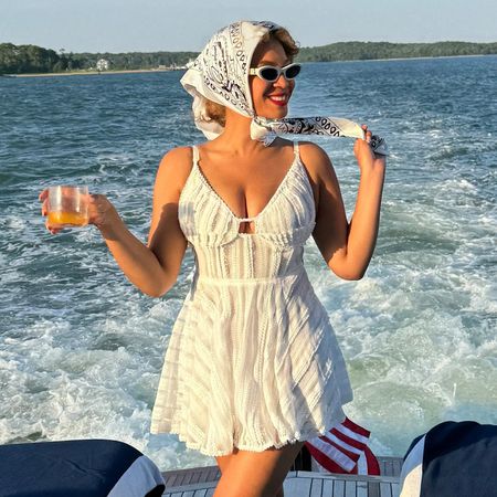 Beyonce on a yacht in the hamptons wearing a white sundress and a bandana tied around her hair