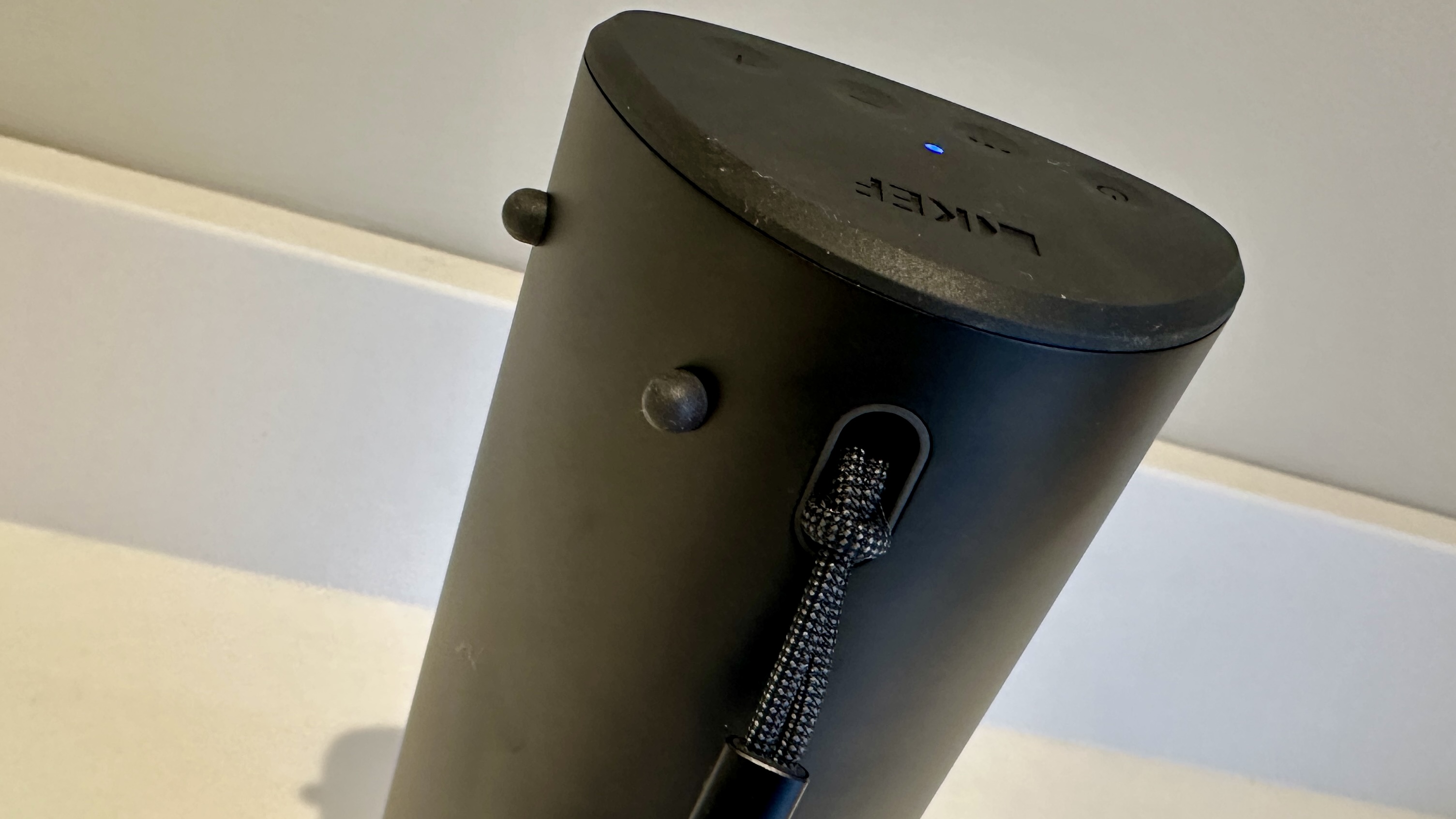 KEF Muo 2025 in black, on a white table