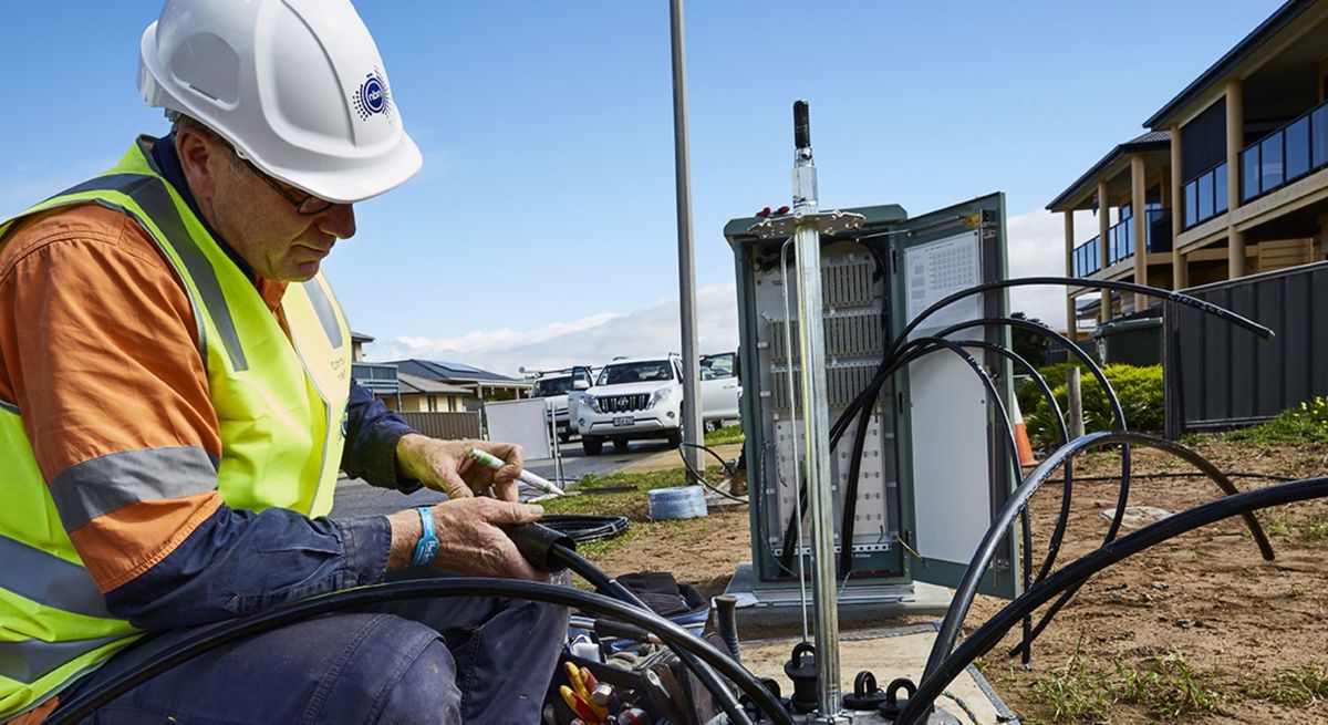 An NBN technician working on an NBN distribution box