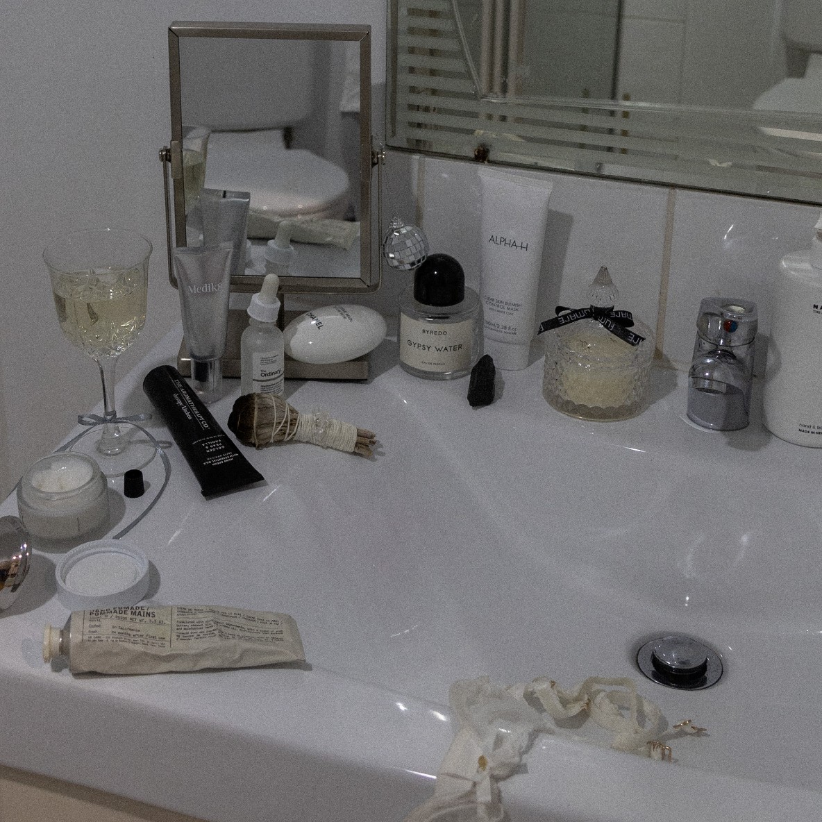 Photo of skincare products on a bathroom sink