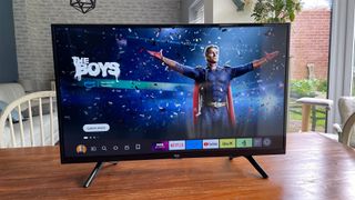 Amazon Fire TV 32-inch 2-Series (HD32N200U) 32-inch TV on wooden table with The Boys on Amazon OS screen
