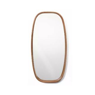 A rectangular curved light brown mirror with glass in the middle of it
