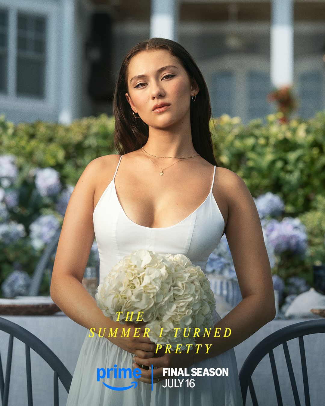 Belly wearing white dress and holding white bouquet