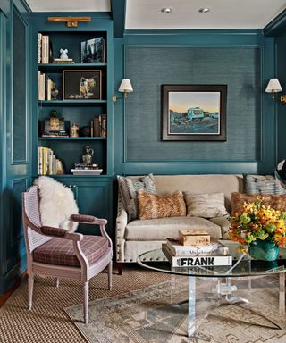 sitting area with blue textured walls and cream sofa and tweed cushioned chair