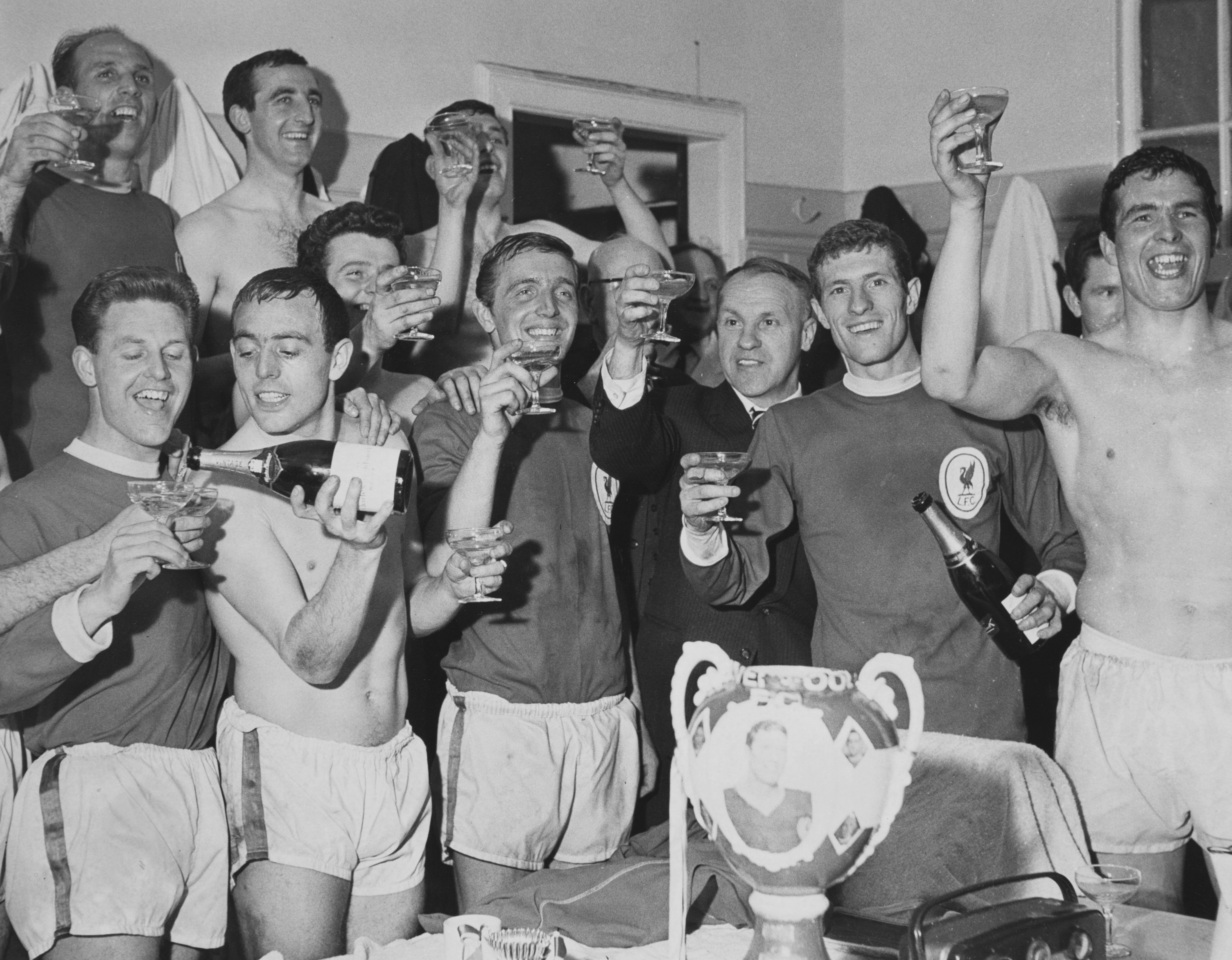 Liverpool players celebrate in the dressing room after clinching the First Division title with a 5-0 win at Arsenal in April 1964.