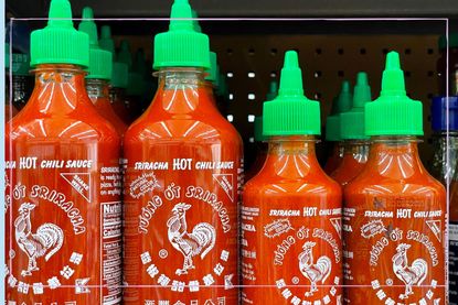 Bottles of Sriracha on a shelf in a store