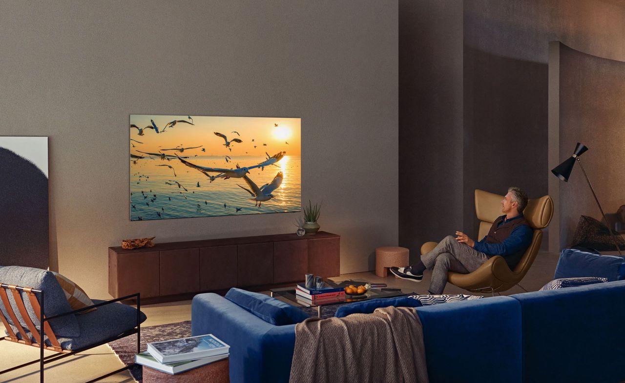 Samsung TV being watched by man in leather chair