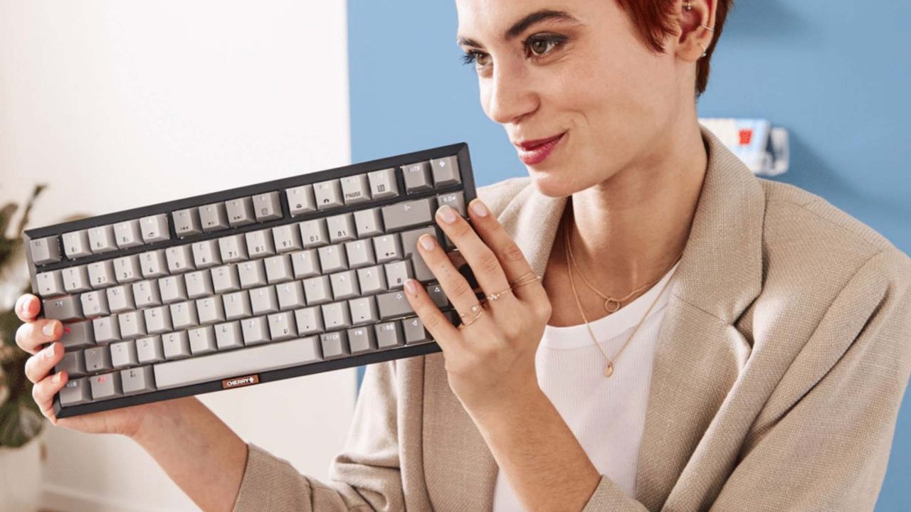 A woman holding the Cherry KW 300 MX.