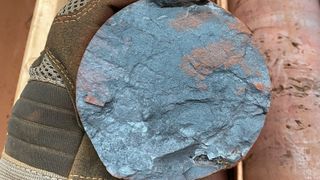 A cross section of a drilling core shows deep blue iron ore from the Hamersley Province.