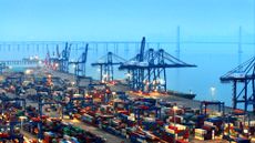 Cargo ships load and unload containers at the container terminal of Shihu Port in Shishi City, China