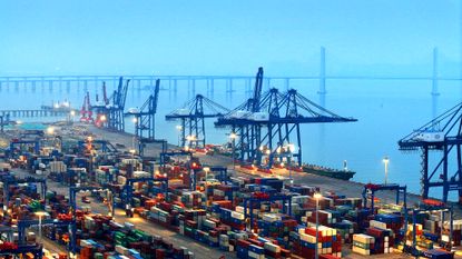 Cargo ships load and unload containers at the container terminal of Shihu Port in Shishi City, China
