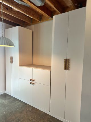 An IKEA BESTA unit with two PAX closets to make built-in wall storage