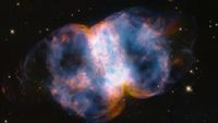 a blue-and-orange cloud of gas in space, roughly shaped like an hourglass